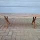 French country style cast iron bench with old rustic wooden plank