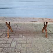 French country style cast iron bench with old rustic wooden plank