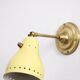 Wall lamp inlaiton and pale yellow lacquered metal