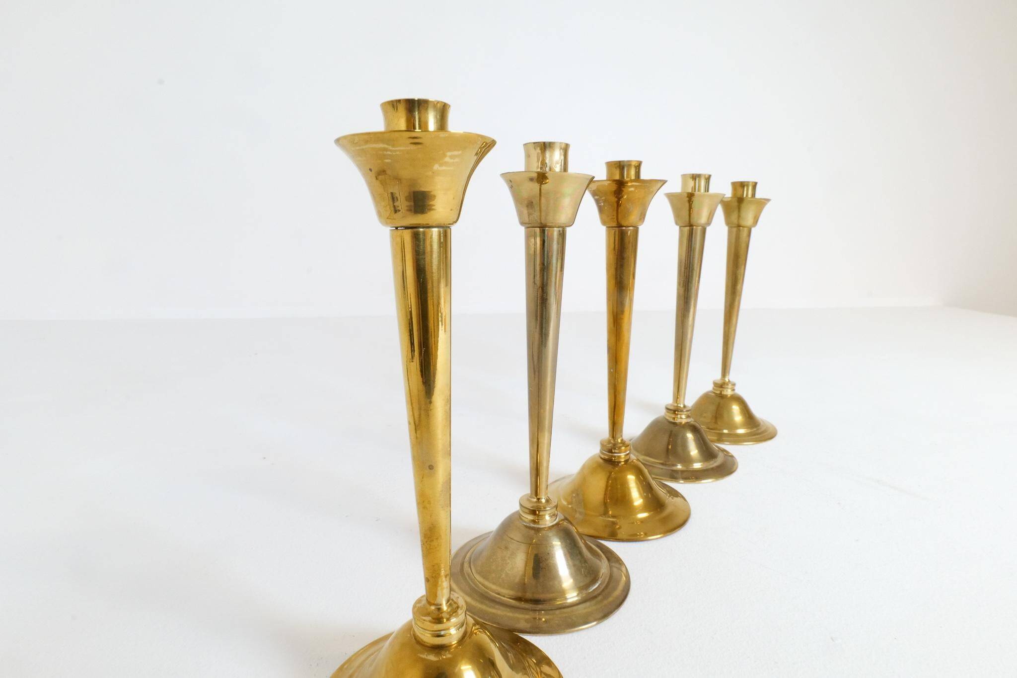 Mid-century set of 5 brass candlesticks by Lars Holmström, Arvika, Sweden.