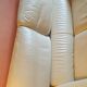 Two-seater convertible sofa bed in off-white leather by Ligne Roset.