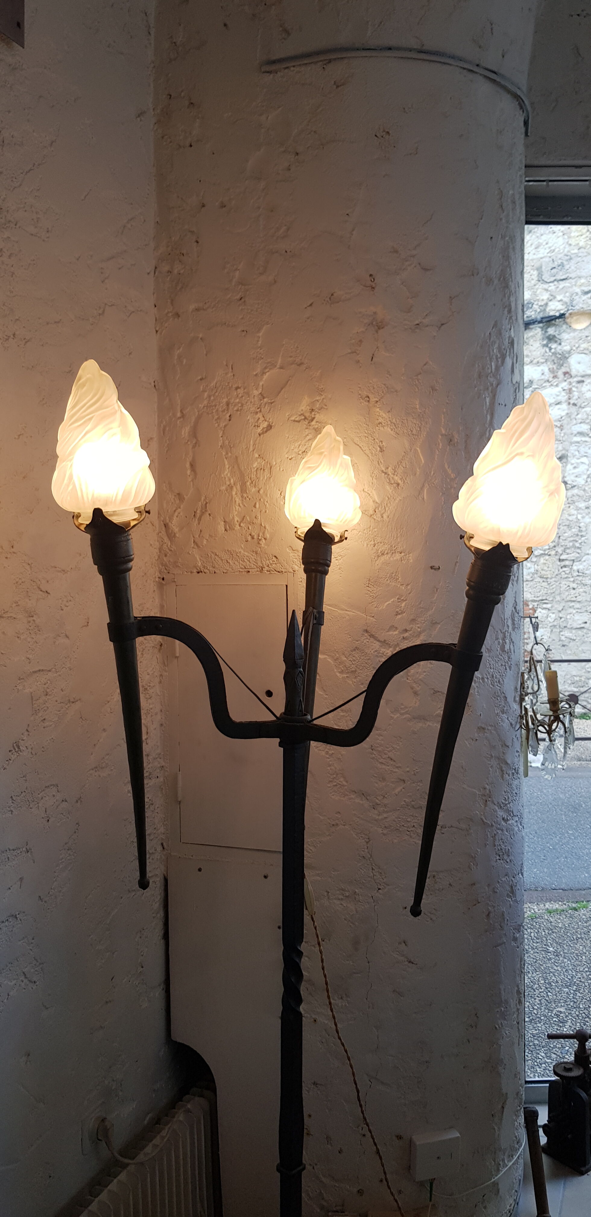 Old wrought iron tripod lamppost