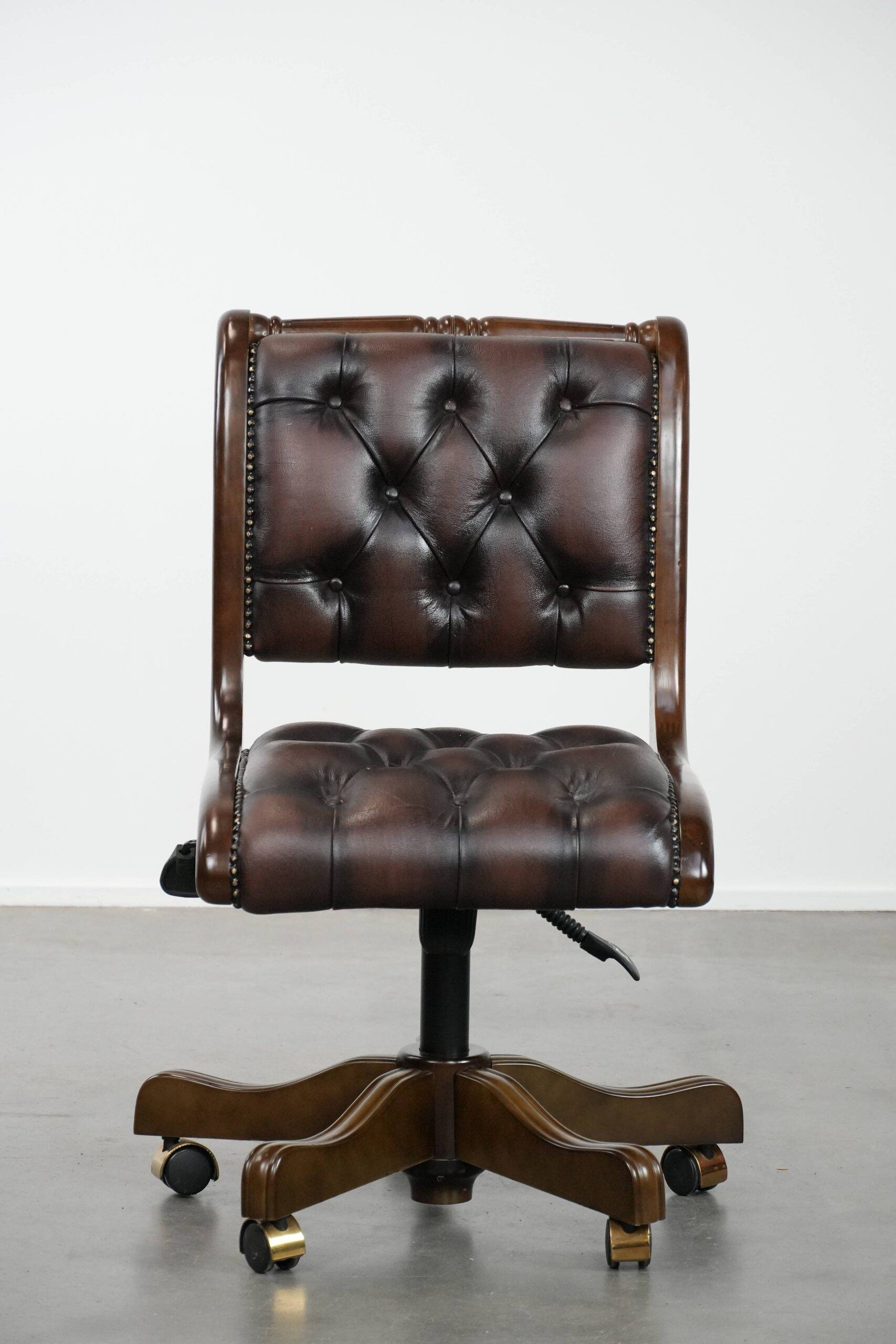 Chesterfield office chair in English style made of cow leather and wood.