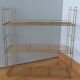 String shelf in golden metal wires