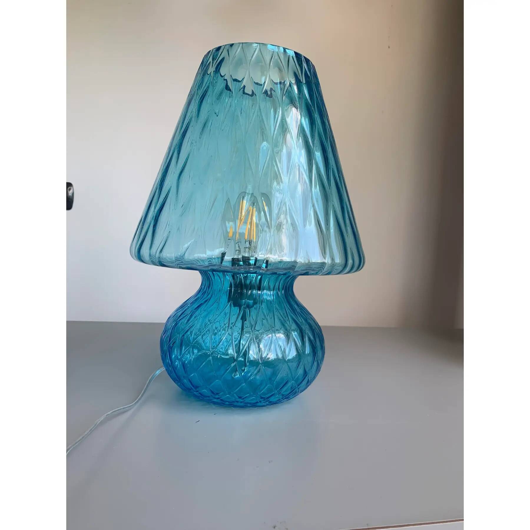 Light blue Murano-style glass with a balloton lamp.