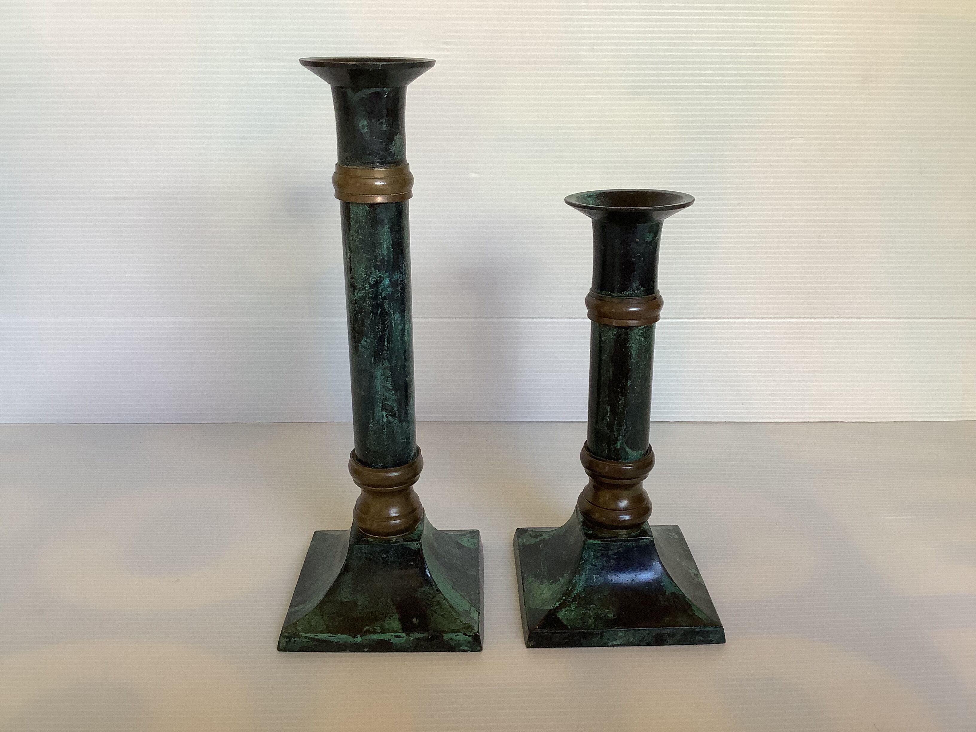 Pair of green patinated brass candlesticks