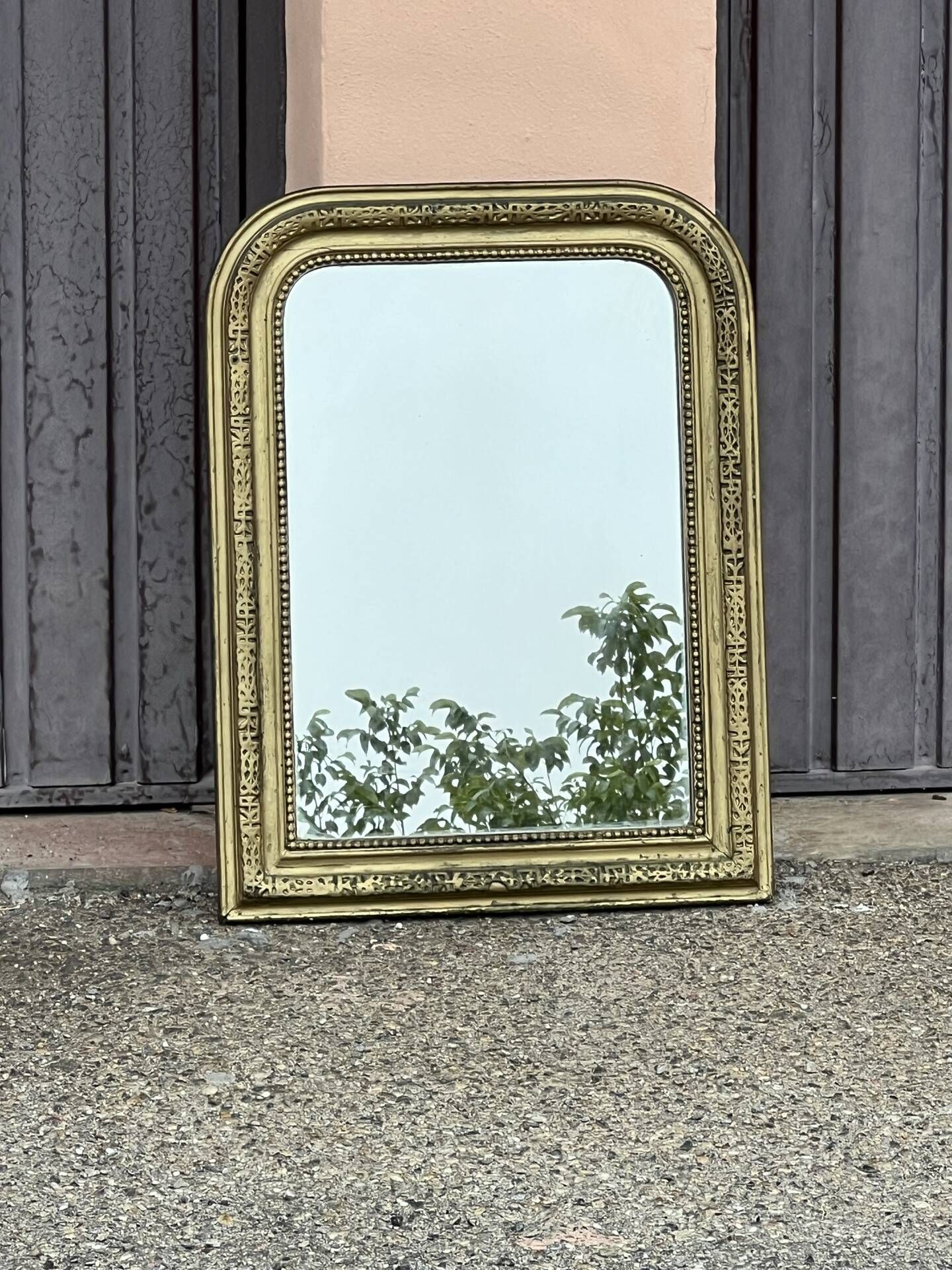 Louis Philippe mirror in gilded wood with an openwork frieze.
