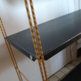 String shelf in gold and black metal