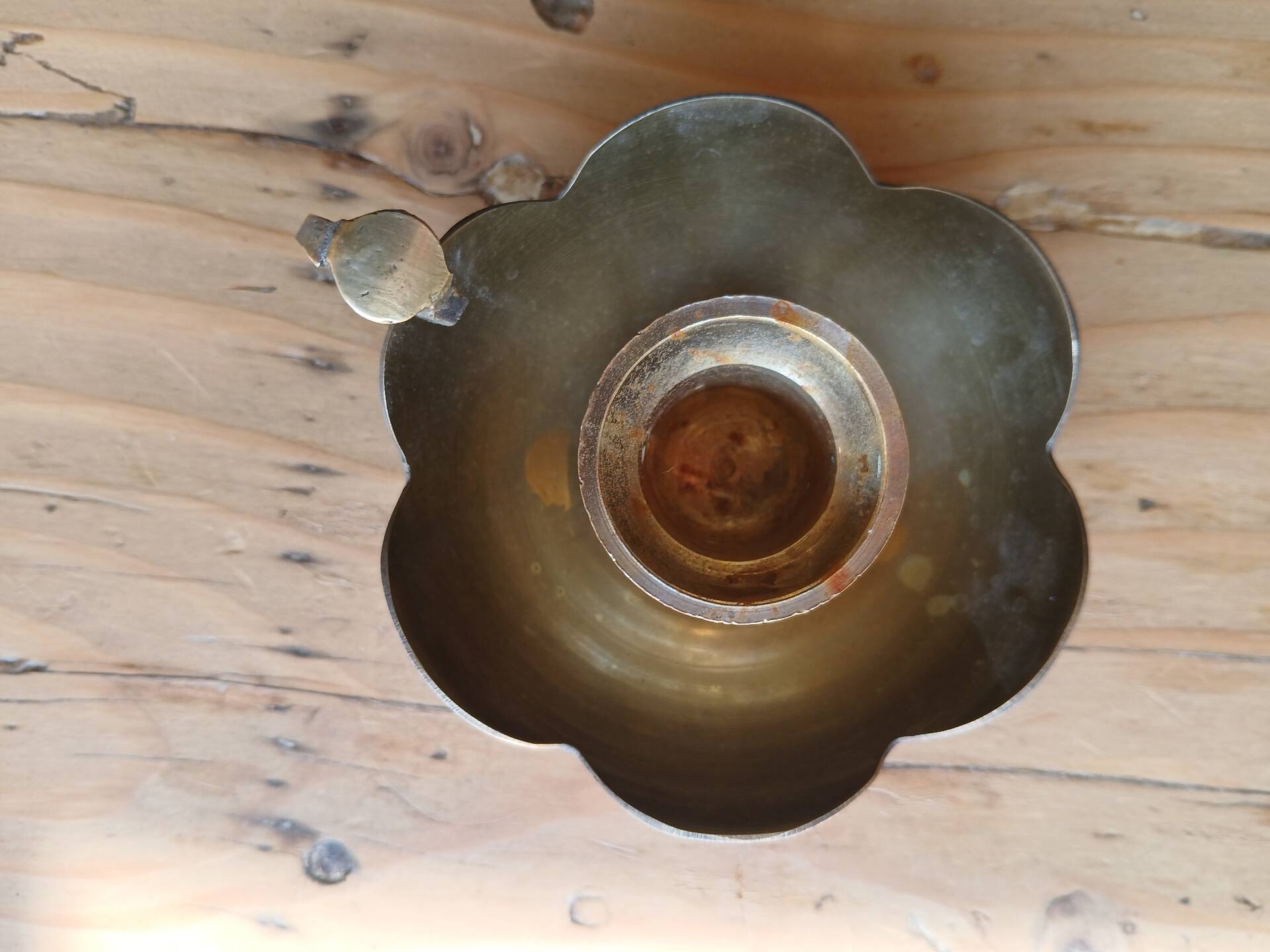 Brass candle holder in the shape of a flower.