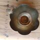 Brass candle holder in the shape of a flower.