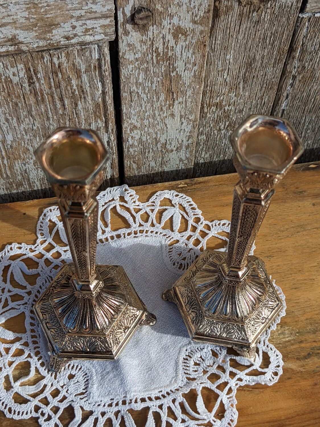 Pair of chiseled metal candle holders