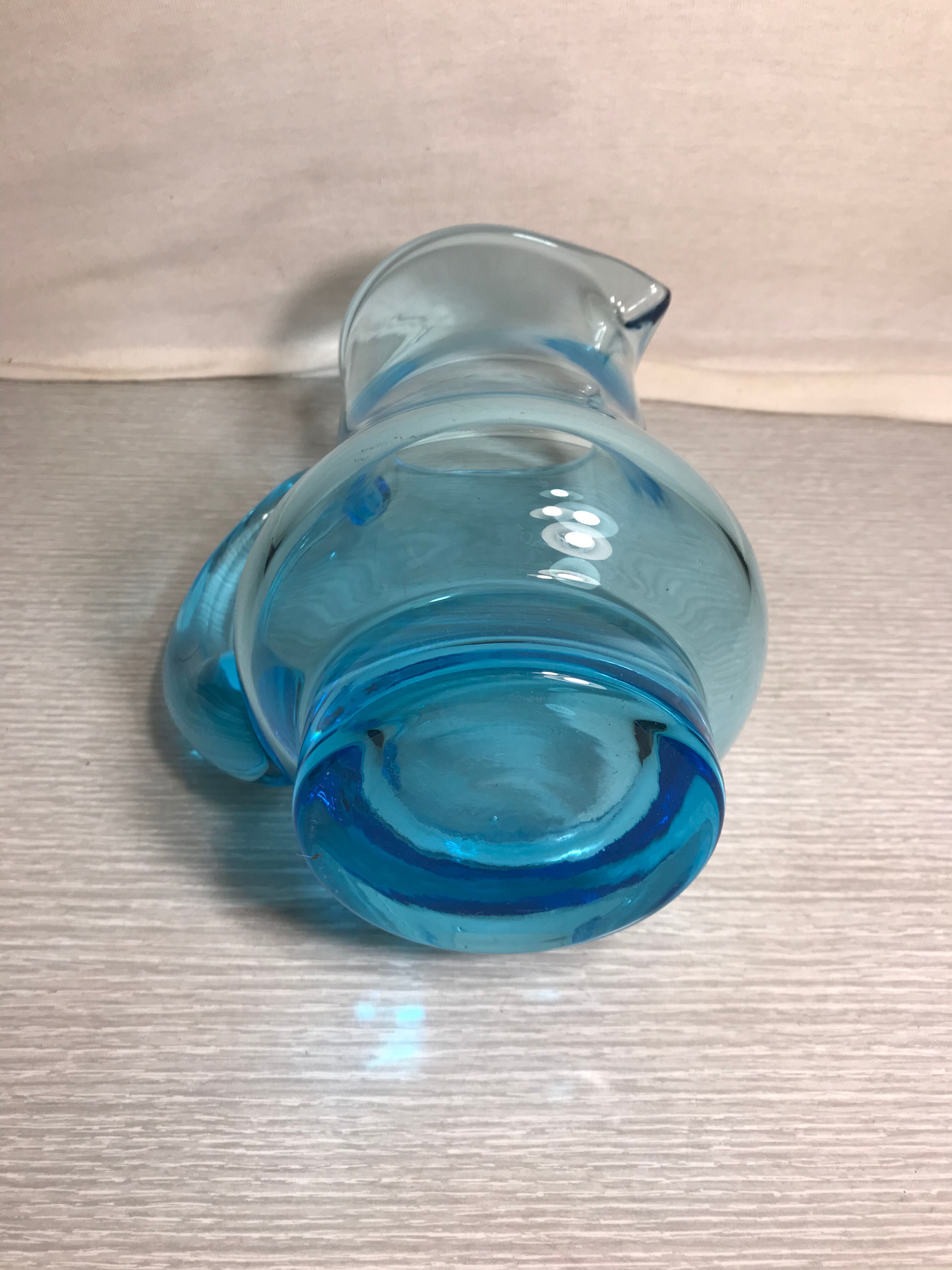 Old blue blown glass pitcher with vintage handle
