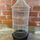 Antique black & white metal bird cage on vintage decorative legs
