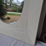 Oval mirror with a distressed white frame