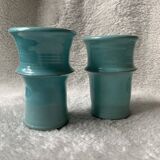 Two lovely turquoise ceramic mug vases.