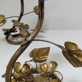 Pair of brass candle holders decorated with patinated metal flowers