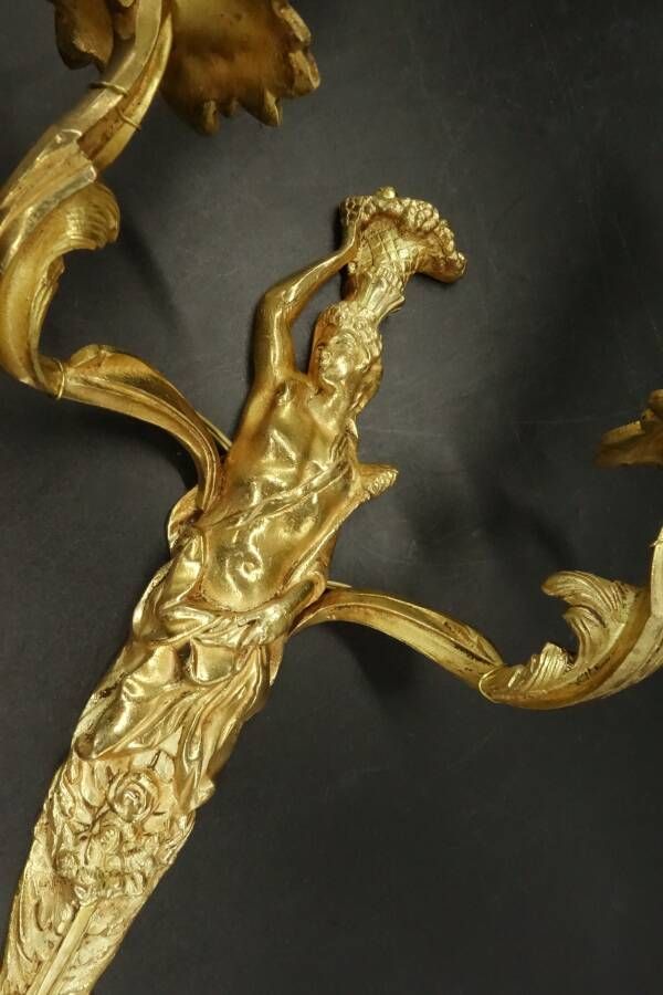 Pair of large caryatid wall sconces in Louis XV style from the 19th century - gilded bronze.
