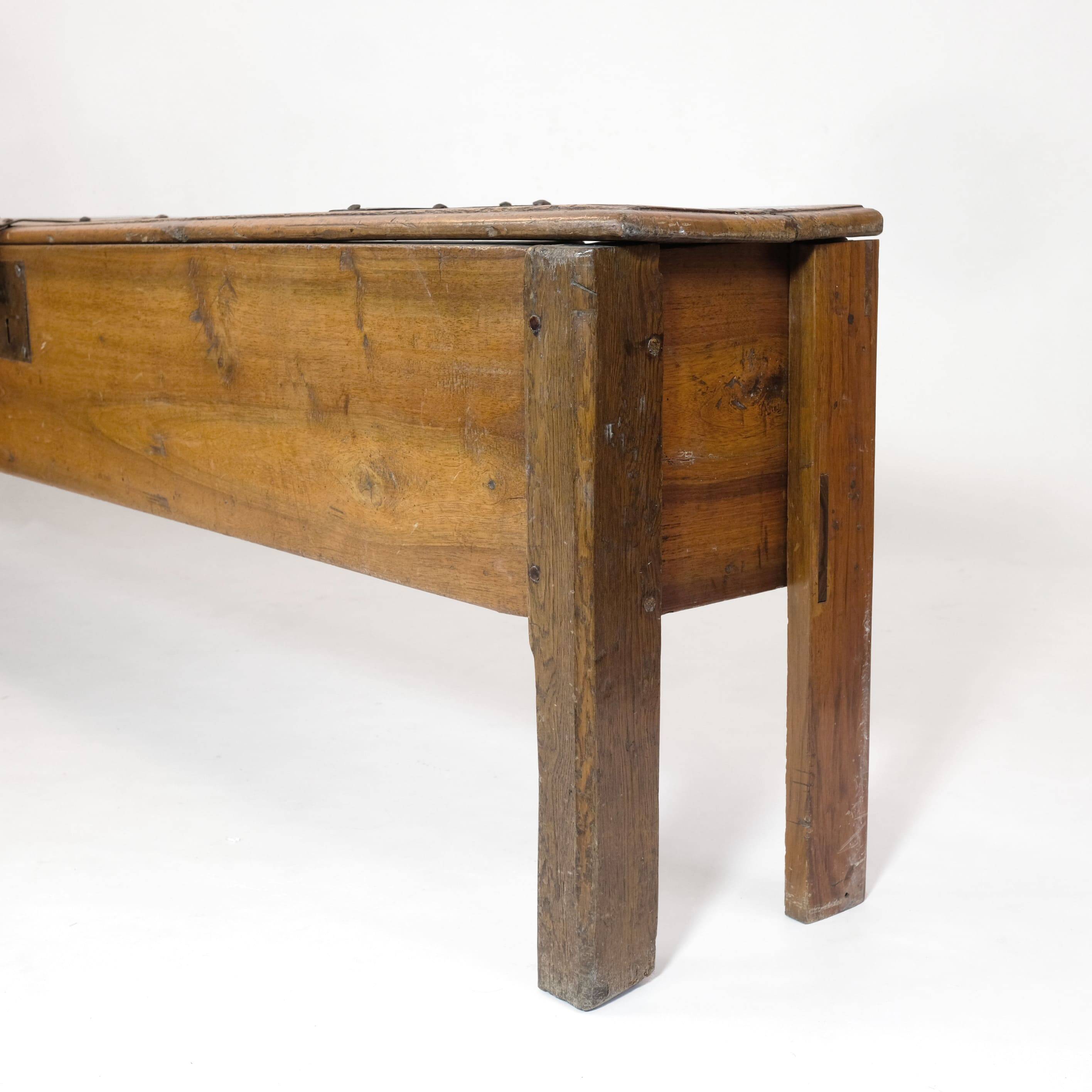 Long walnut grain chest forming a bench, 220cm.