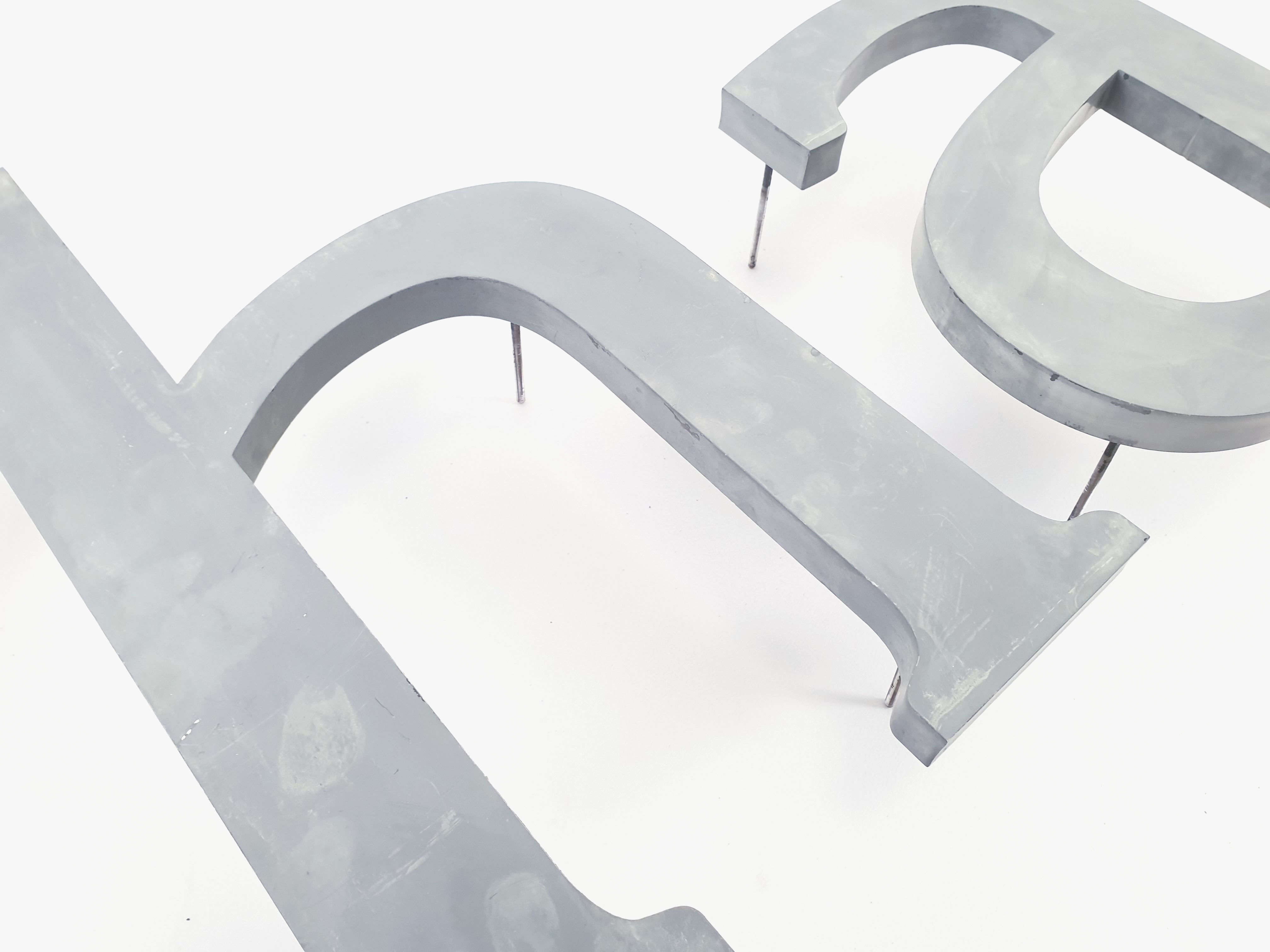 "Ah." sign letters from the patinated grey 70s