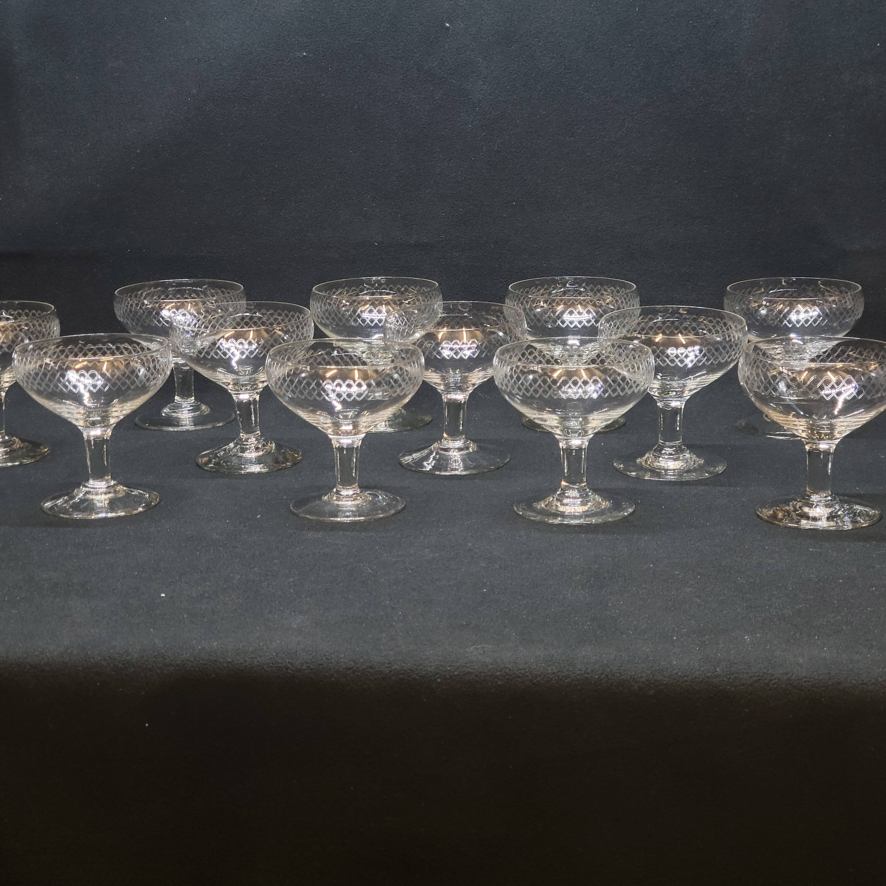 12 old champagne glasses in blown and engraved glass
