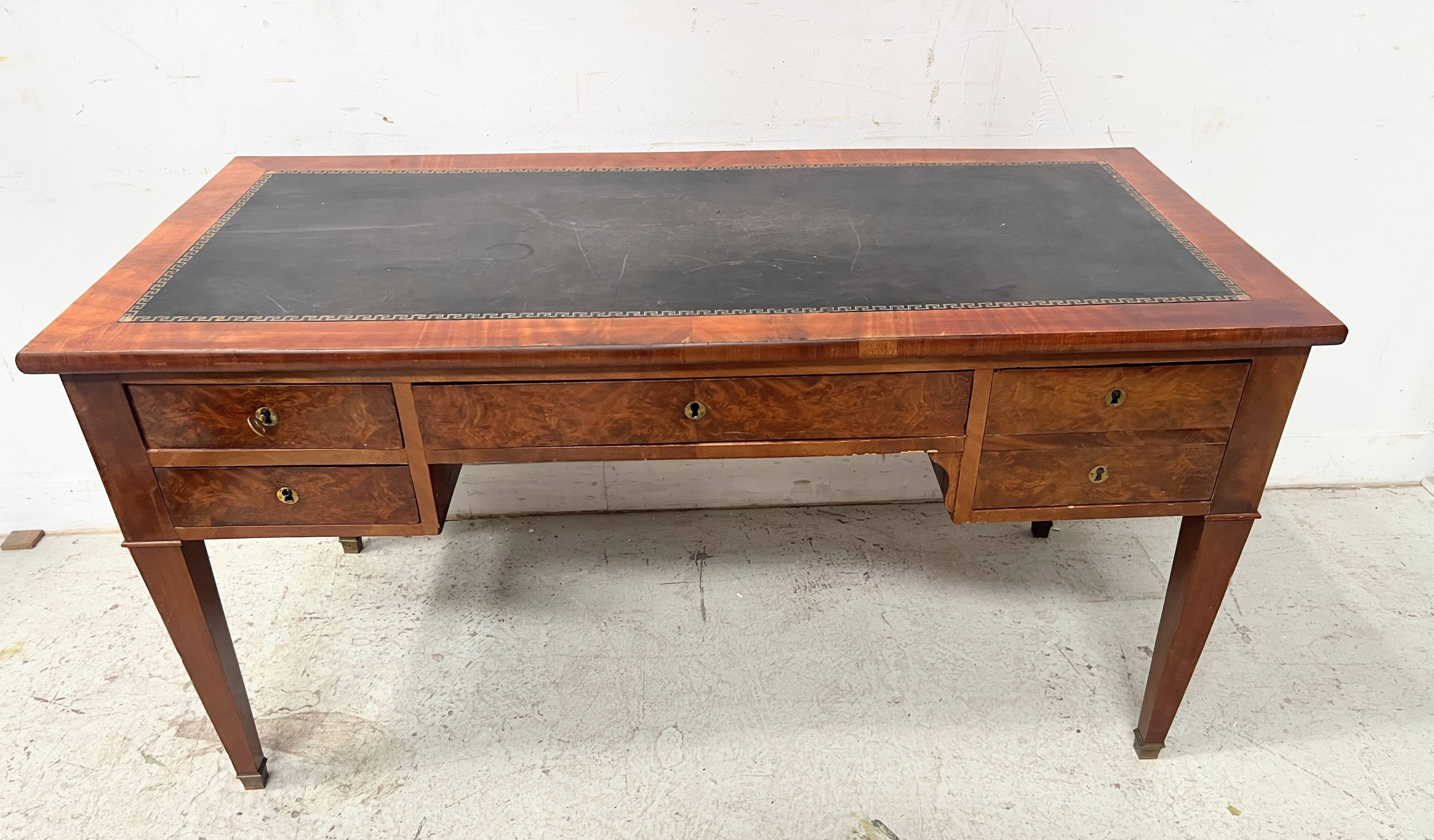 Louis XVI style flat desk in walnut and veneer, 19th century.