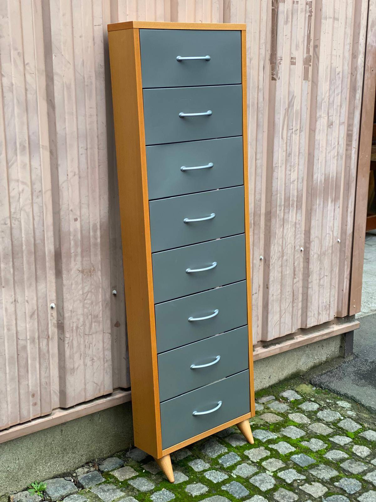 Scandinavian shoe storage cabinet in grey wood and metal.