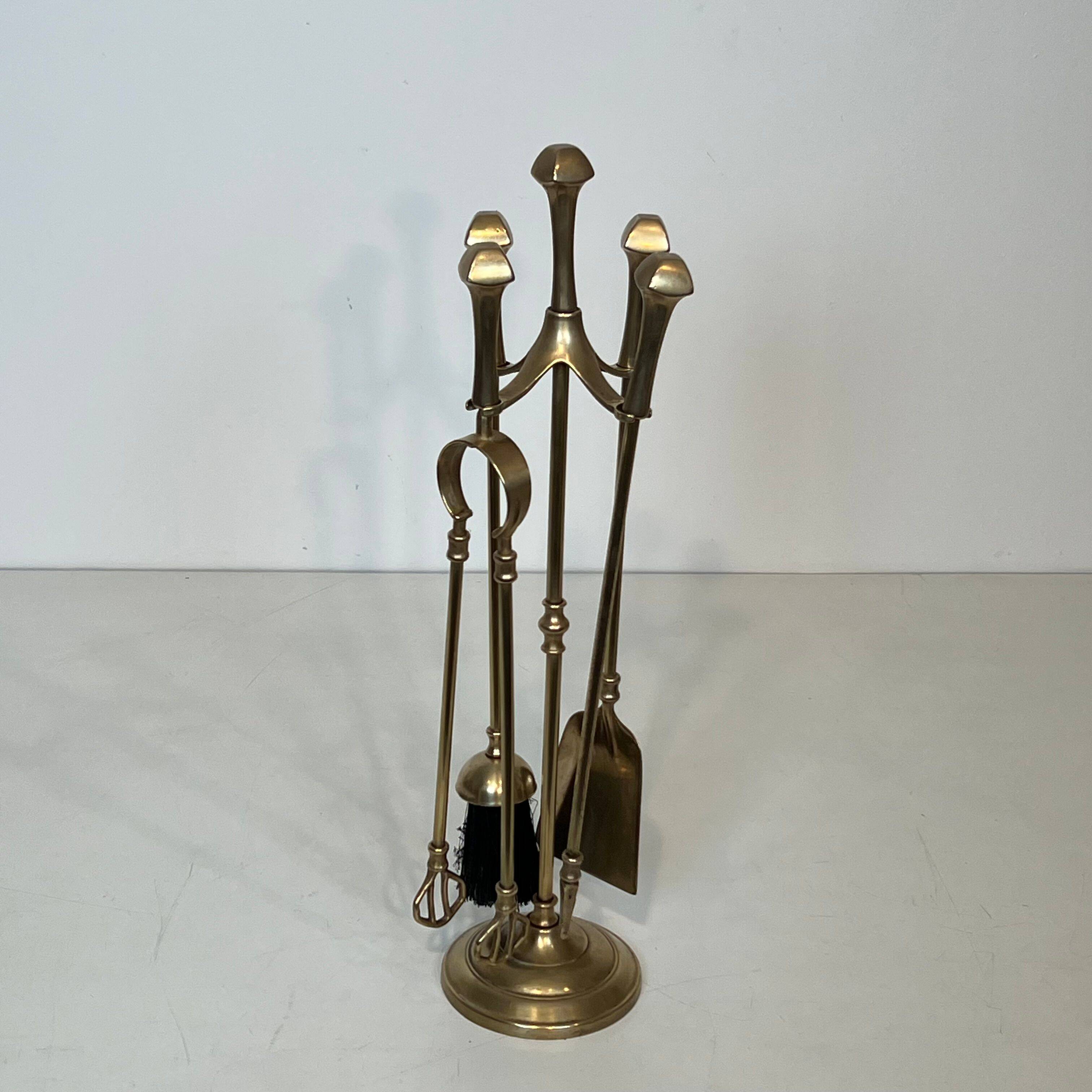 Neoclassical brass fire accessory.