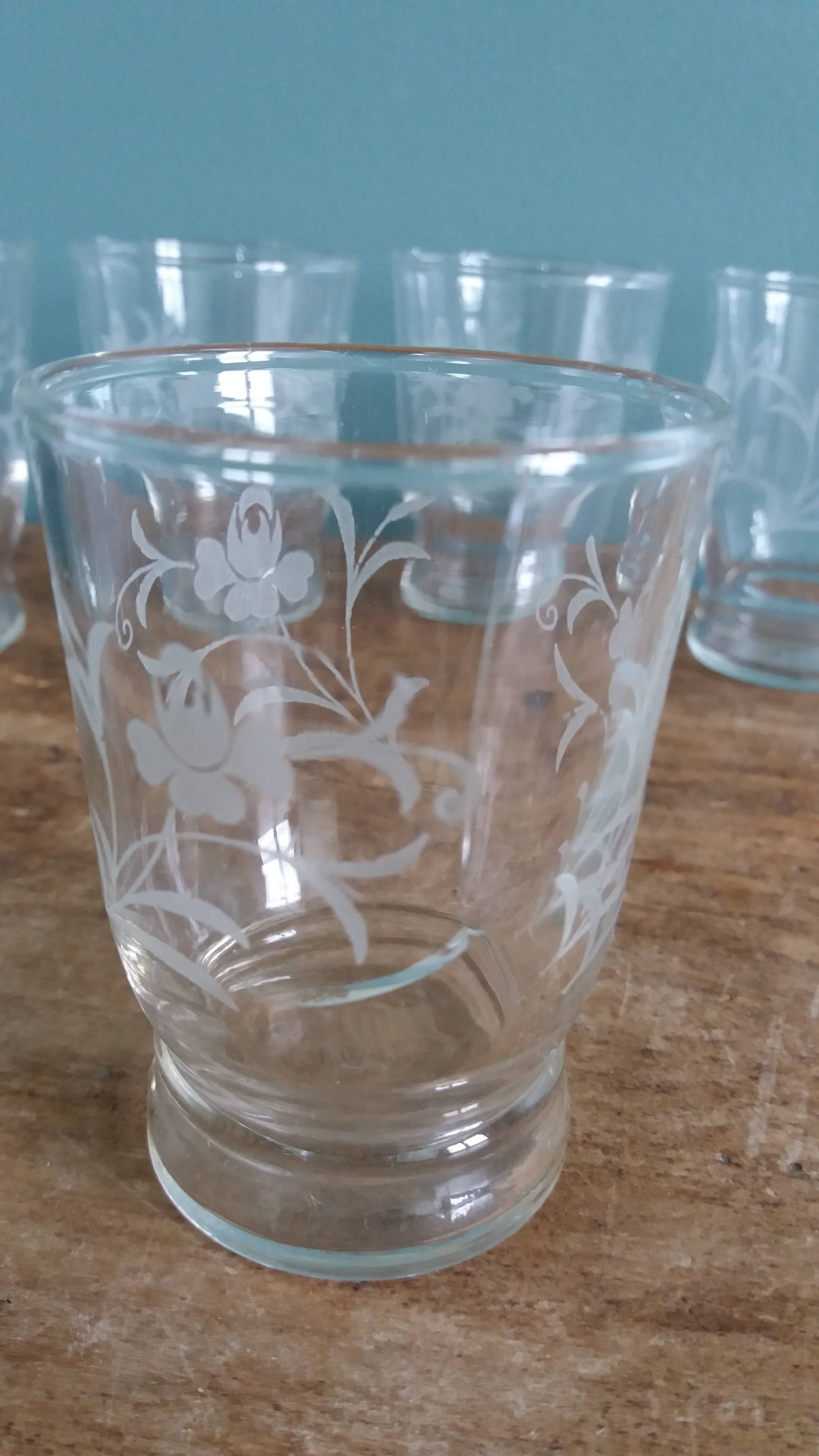 Old digestif or liqueur glasses, handcrafted glass with a floral pattern.
