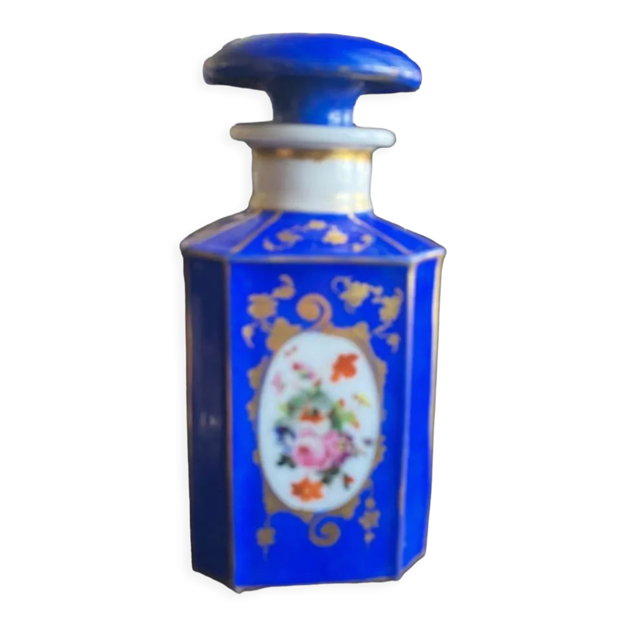 Perfume bottle in porcelain of old paris blue background
