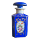 Perfume bottle in porcelain of old paris blue background