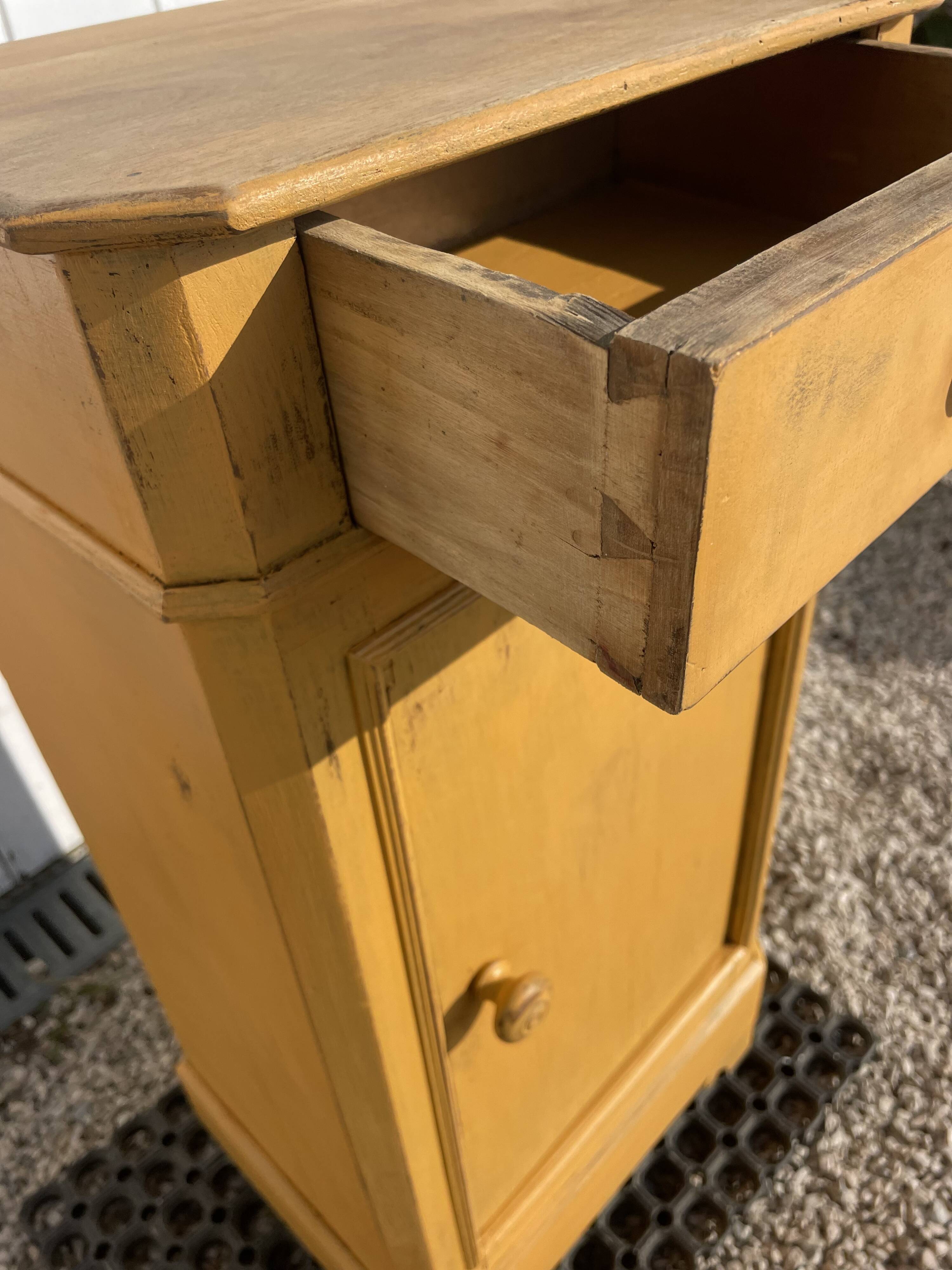 Yellow painted wooden bedside table
