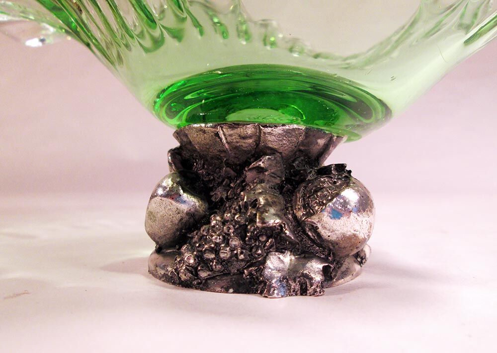 Glass cup on decorated metal stand