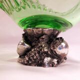 Glass cup on decorated metal stand