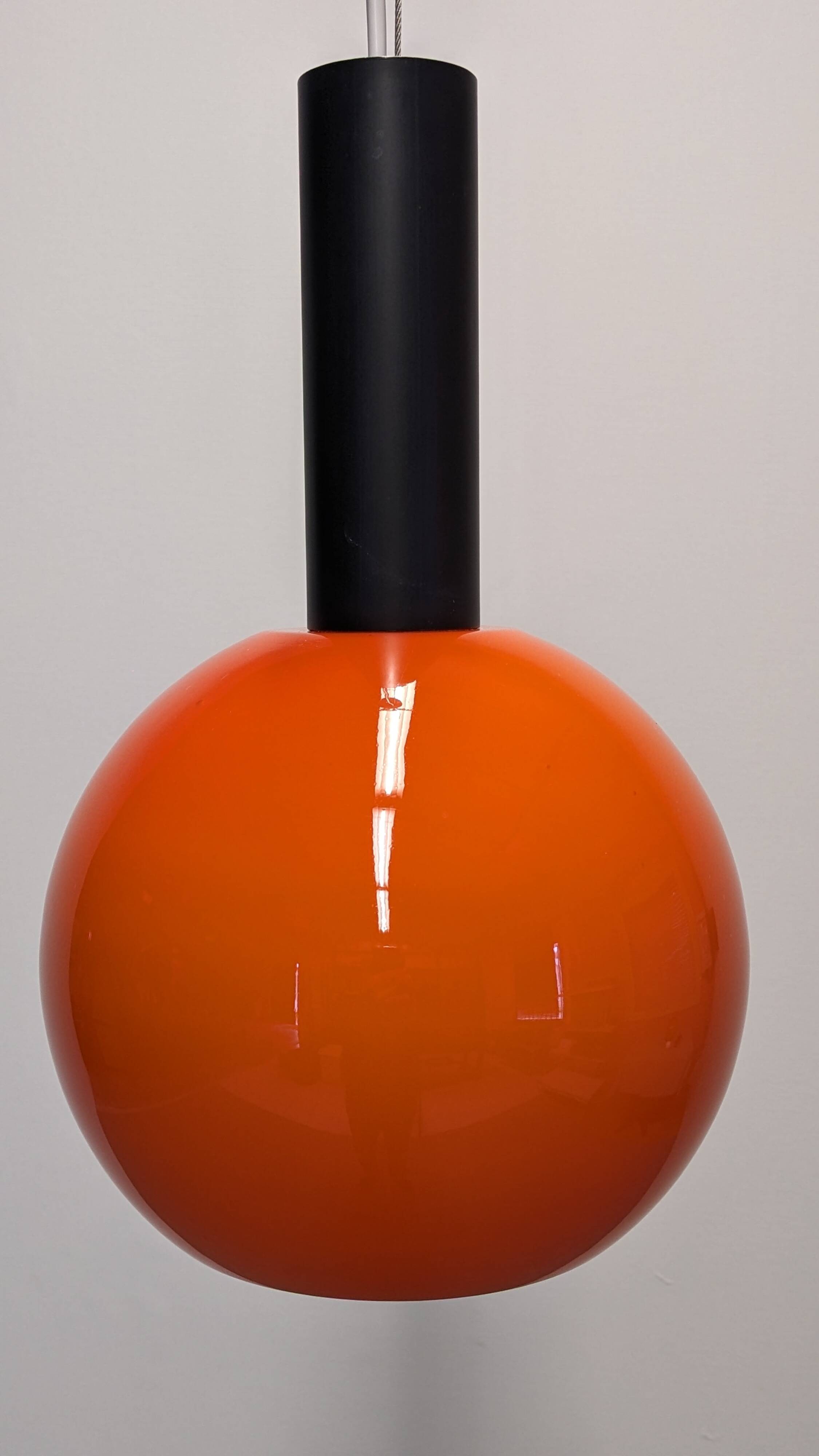 Pair of orange opaline ball pendants by Parscot, France circa 1970.