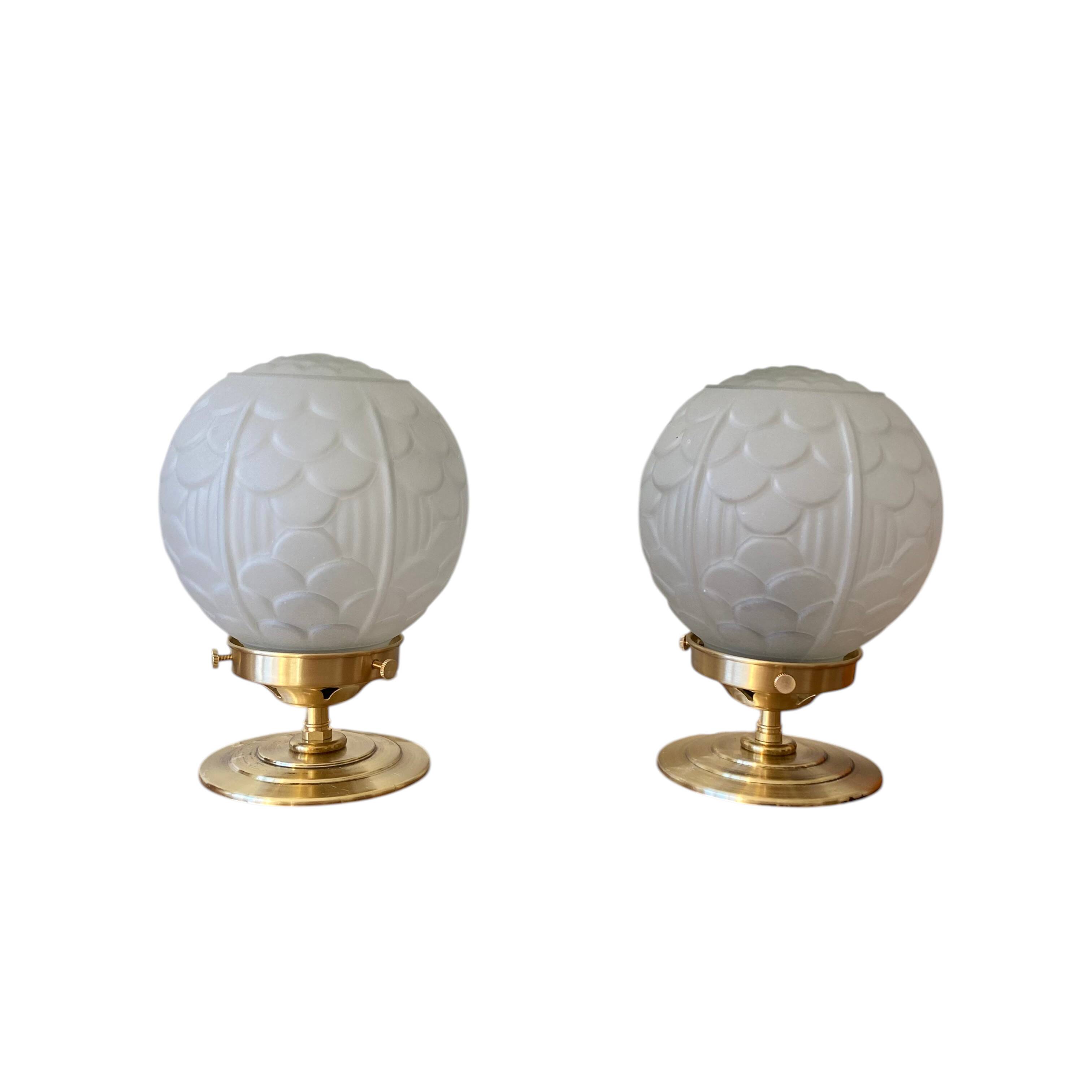 Pair of Art Deco glass globe table lamps with brass base.