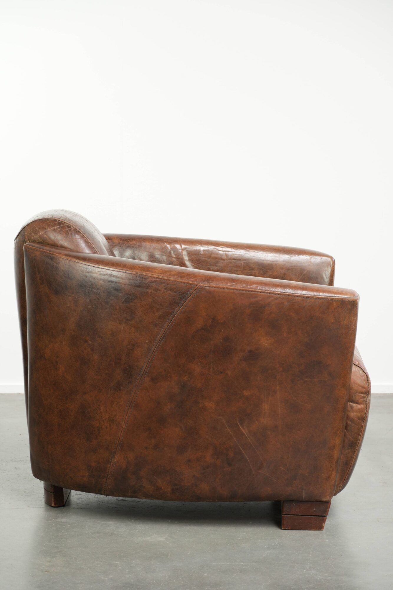Cowhide armchair in Aviator design in a warm brown colour
