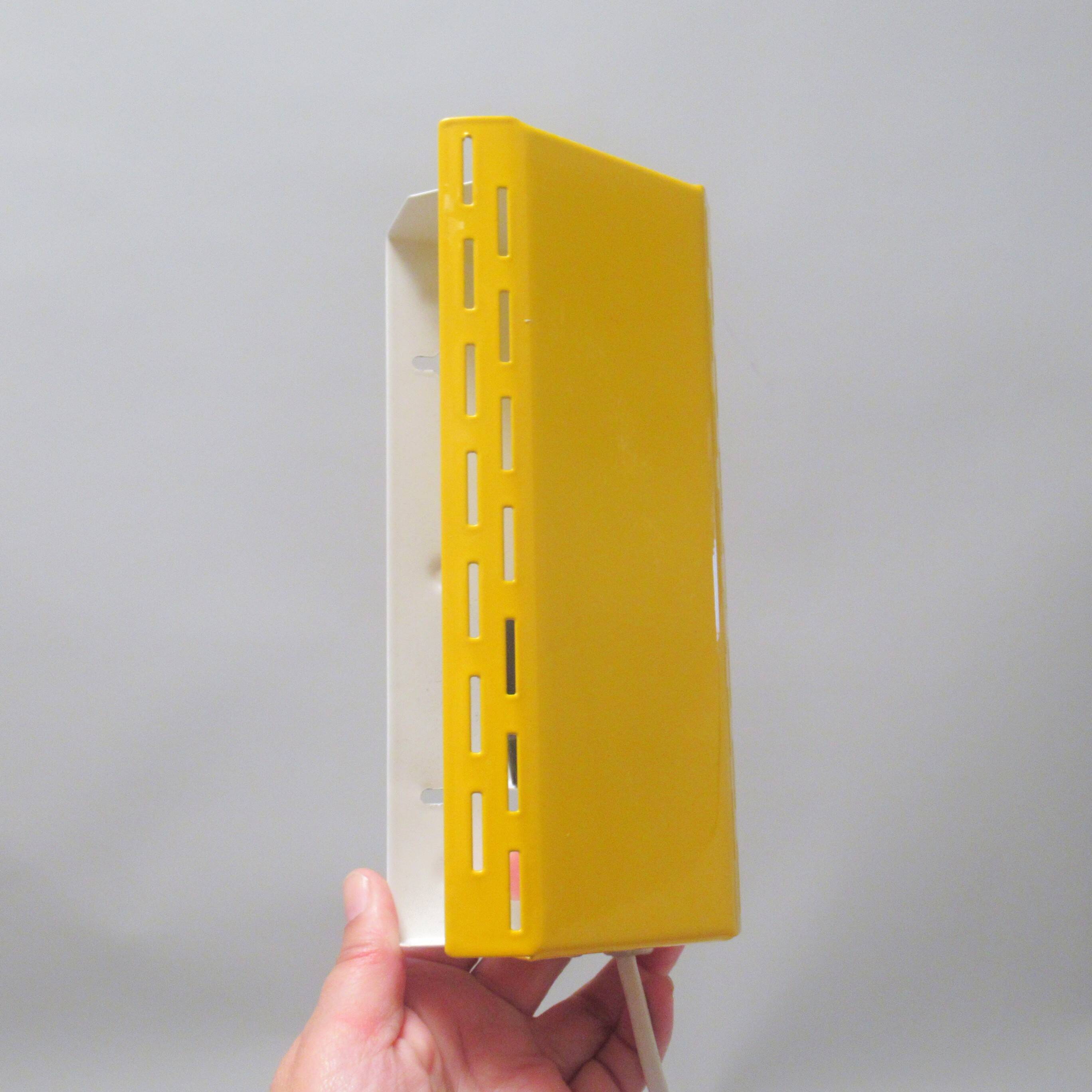 Modernist wall light with a yellow pivoting shade from the 1980s.