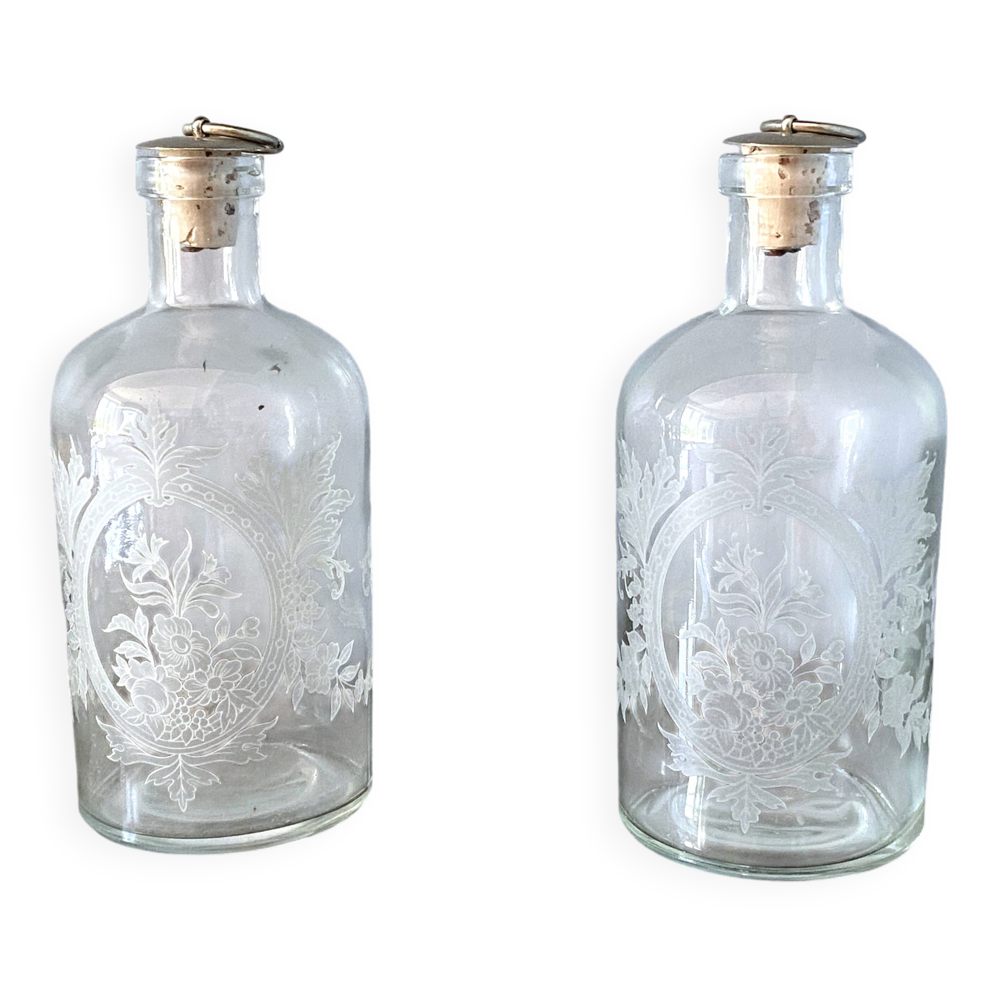 Pair of antique wheel-engraved glass bottles - good condition