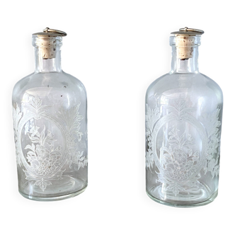 Pair of antique wheel-engraved glass bottles - good condition