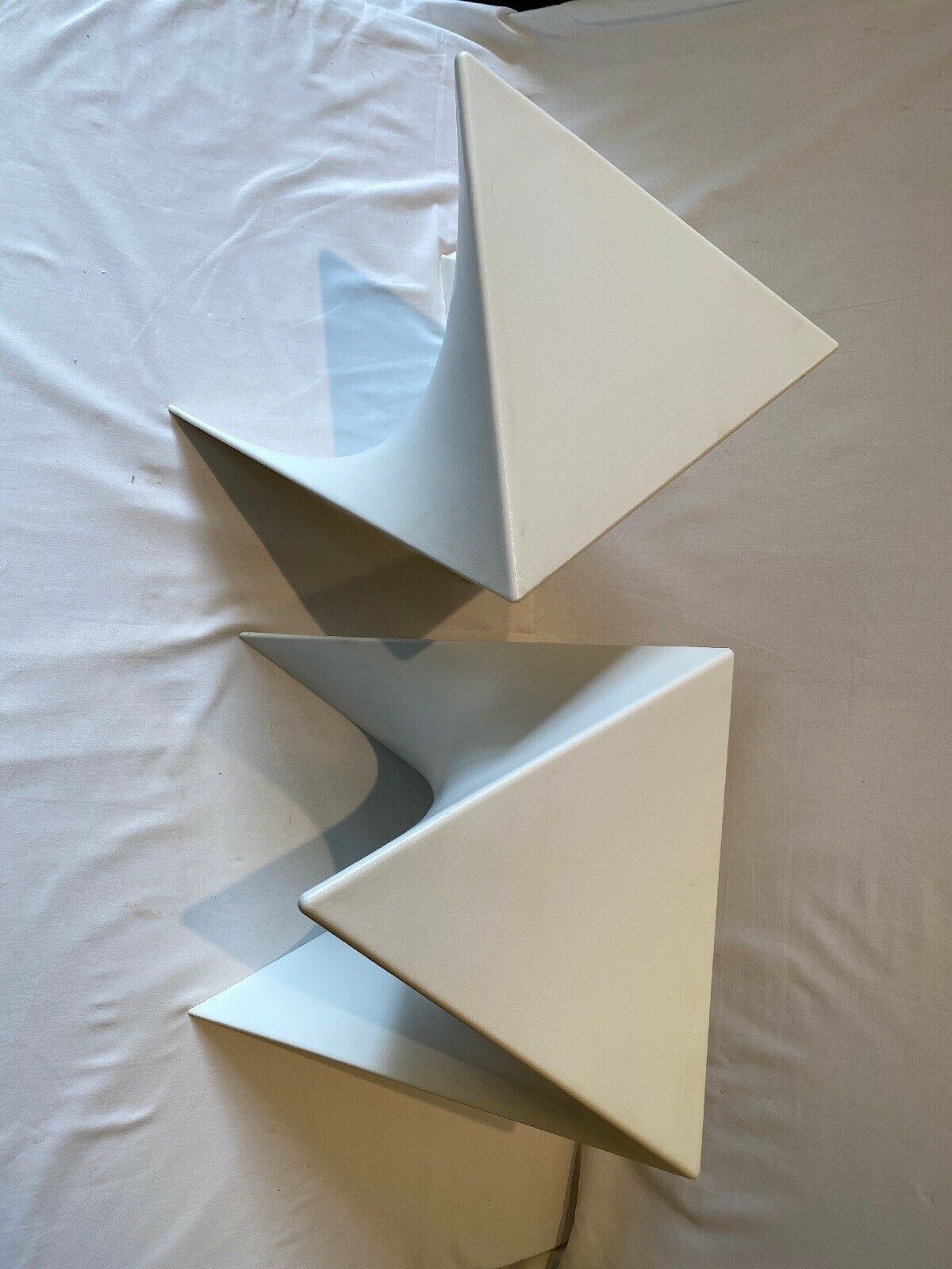 Pair of unmarked triangular white design stools