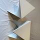 Pair of unmarked triangular white design stools