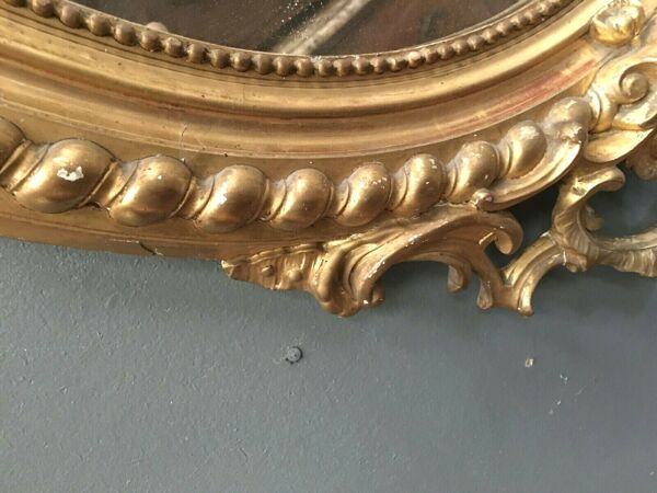 Miroir ovale a fronton en bois et stuc doré Glace ovale biseautée Napoléon III - 80x120cm