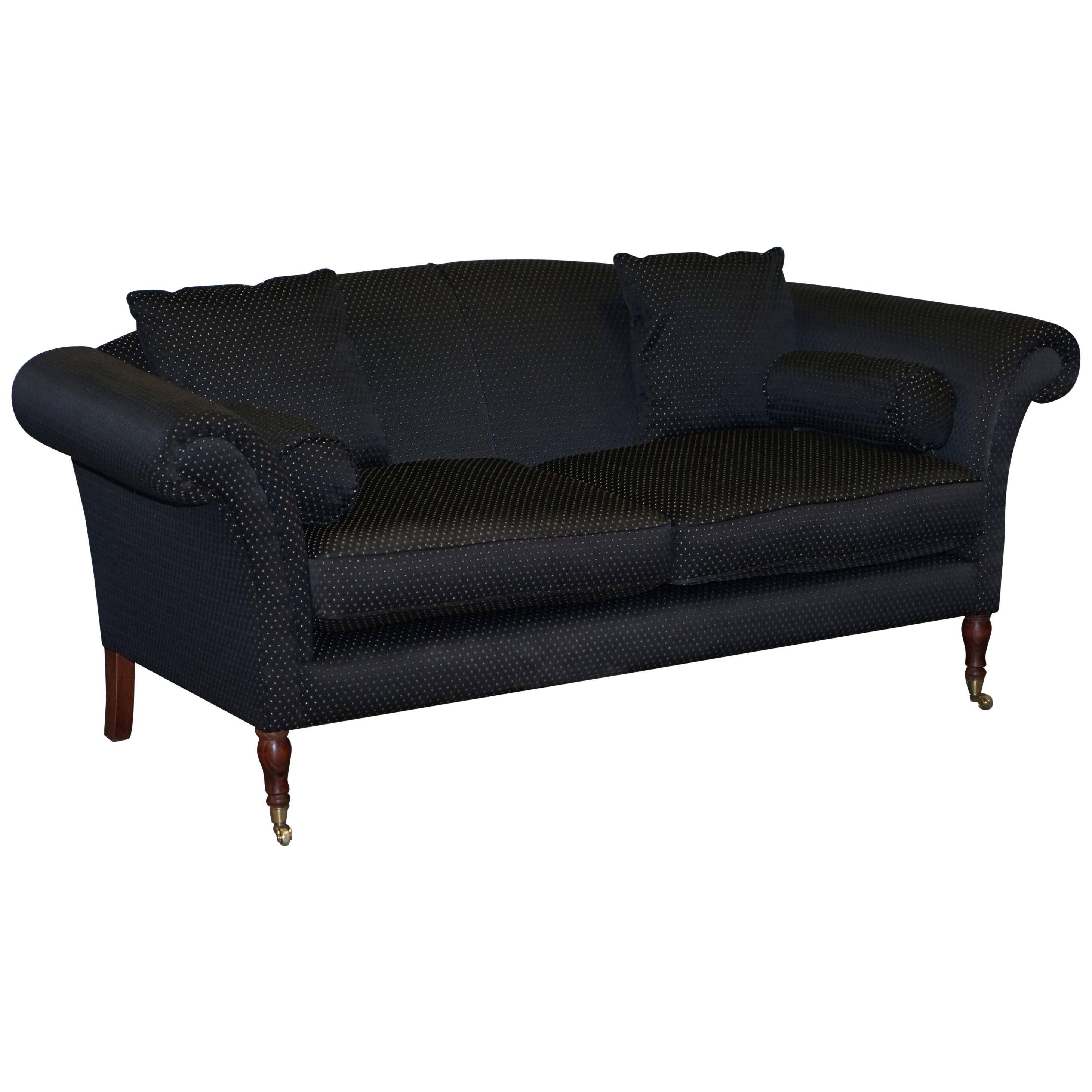 Three-seater Art Deco canapé with a light hardwood frame.