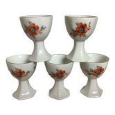 Five old egg cups with orange and grey flowers, polygonal base.