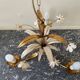 Golden metal chandelier decorated with flowers