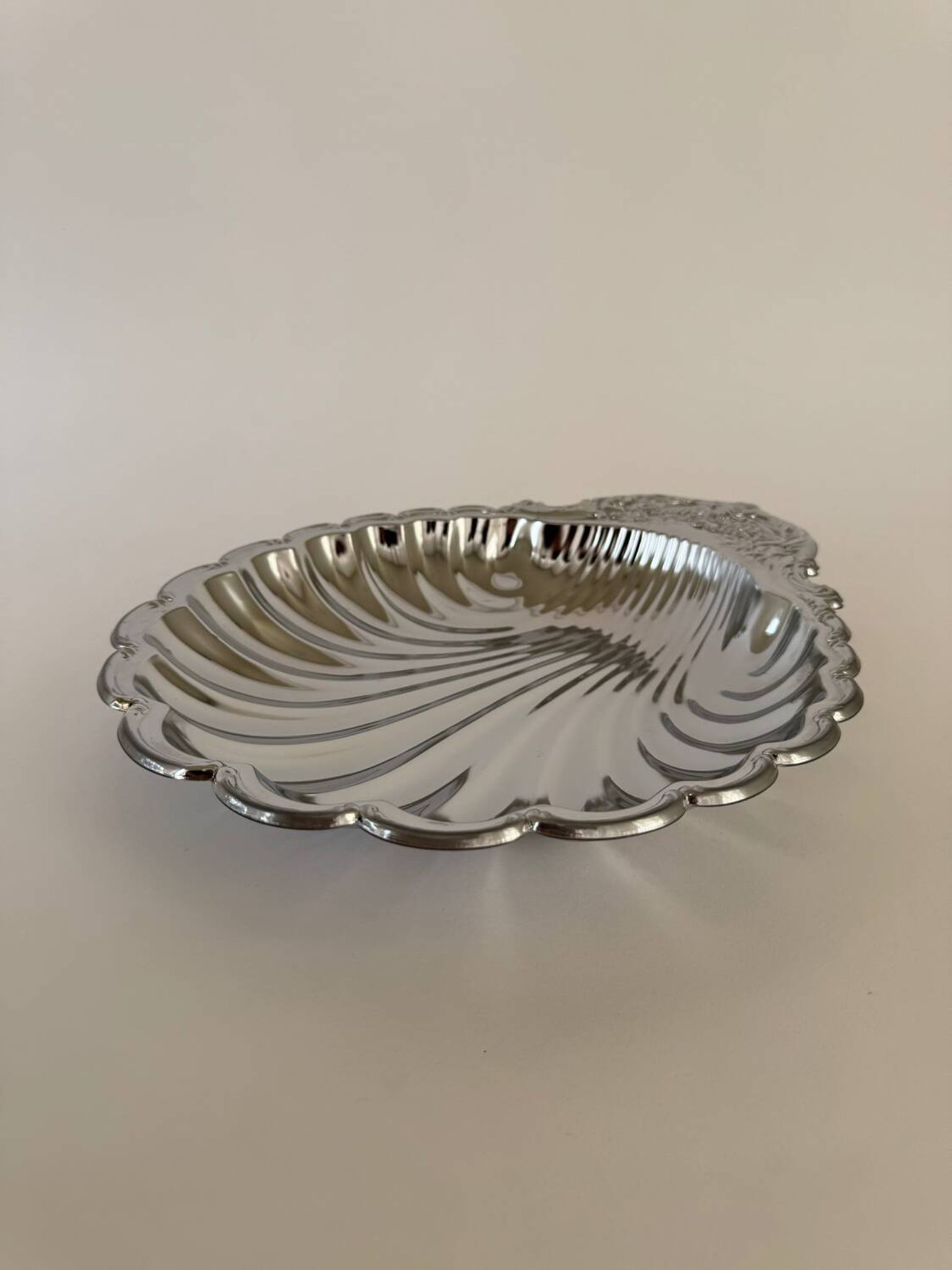 Large silver-plated serving dish in the shape of a vintage shell.