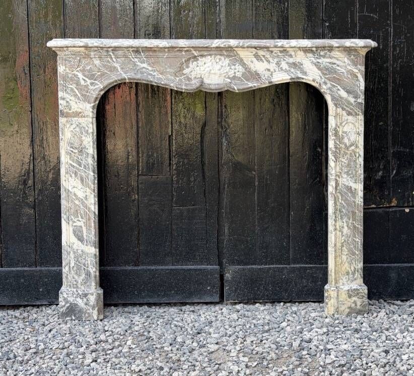 Louis XV fireplace in grey Ardennes marble, a floral basket in white marble, late 18th century.