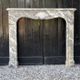 Louis XV fireplace in grey Ardennes marble, a floral basket in white marble, late 18th century.