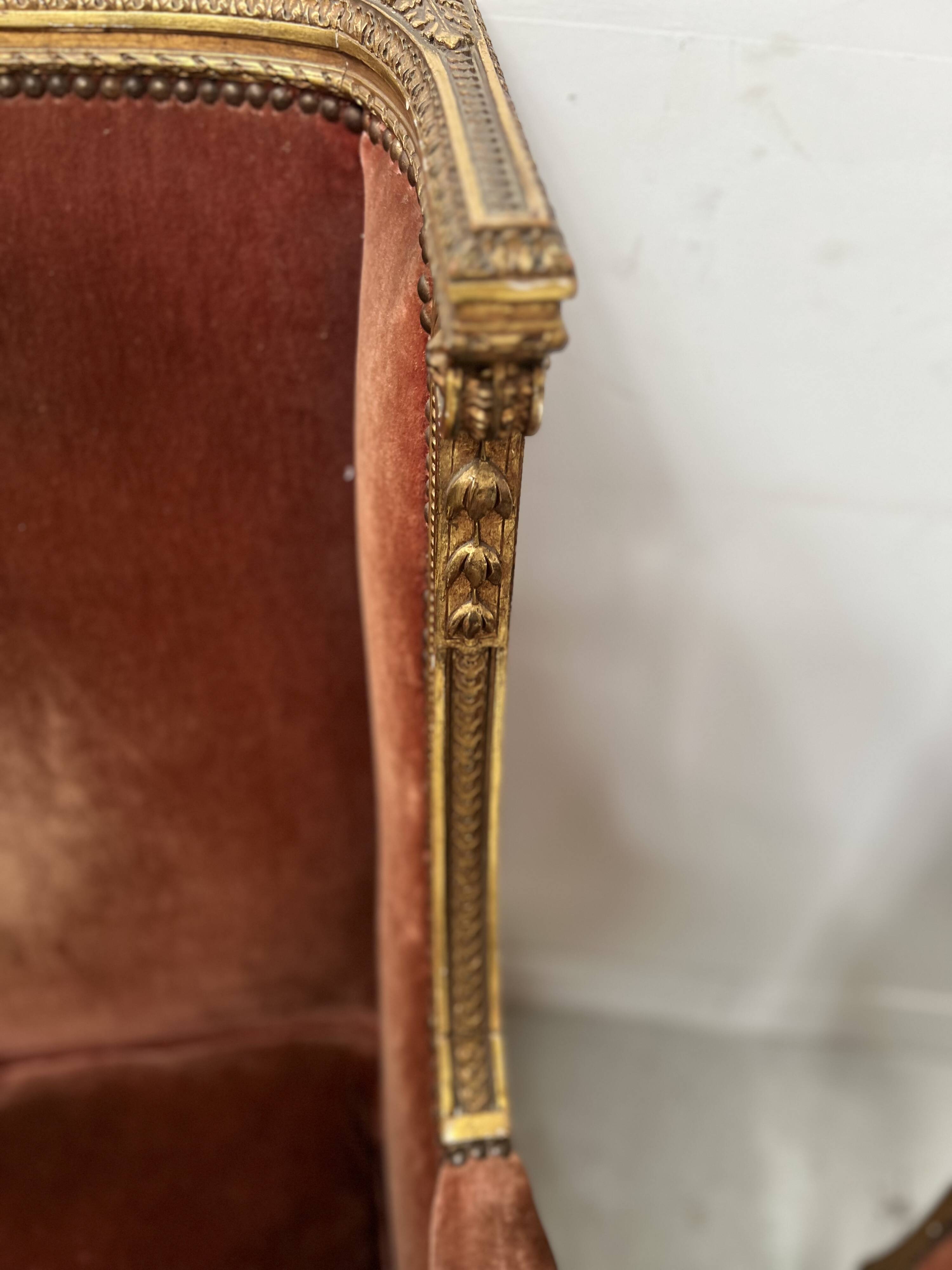 Two Louis XVI style wing chairs in gilded wood, 20th century