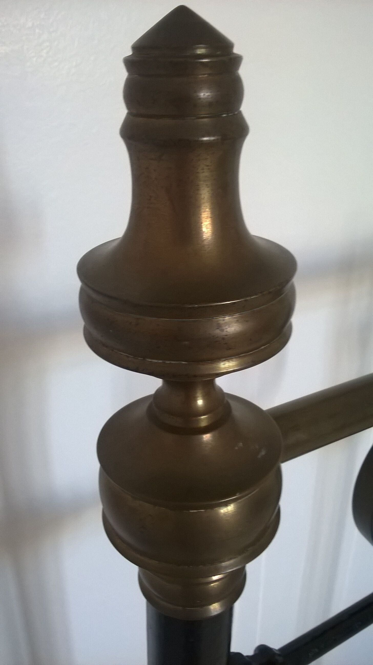 Old bed in black iron and brass